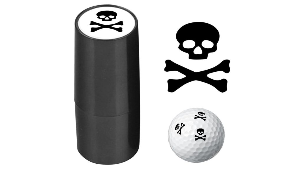 A skull and crossbones golf ball stamp marker