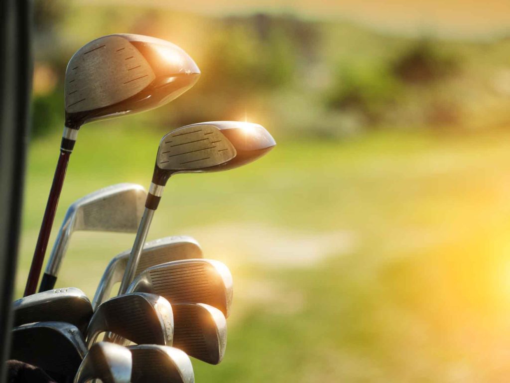 golf clubs in a bag in the sunshine