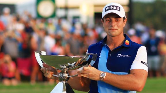Viktor Hovland holding a golf trophy