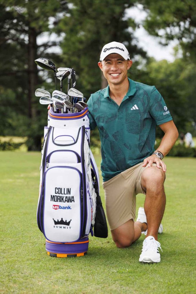 Collin Morikawa kneeling with his new golf bag and looking pretty fly